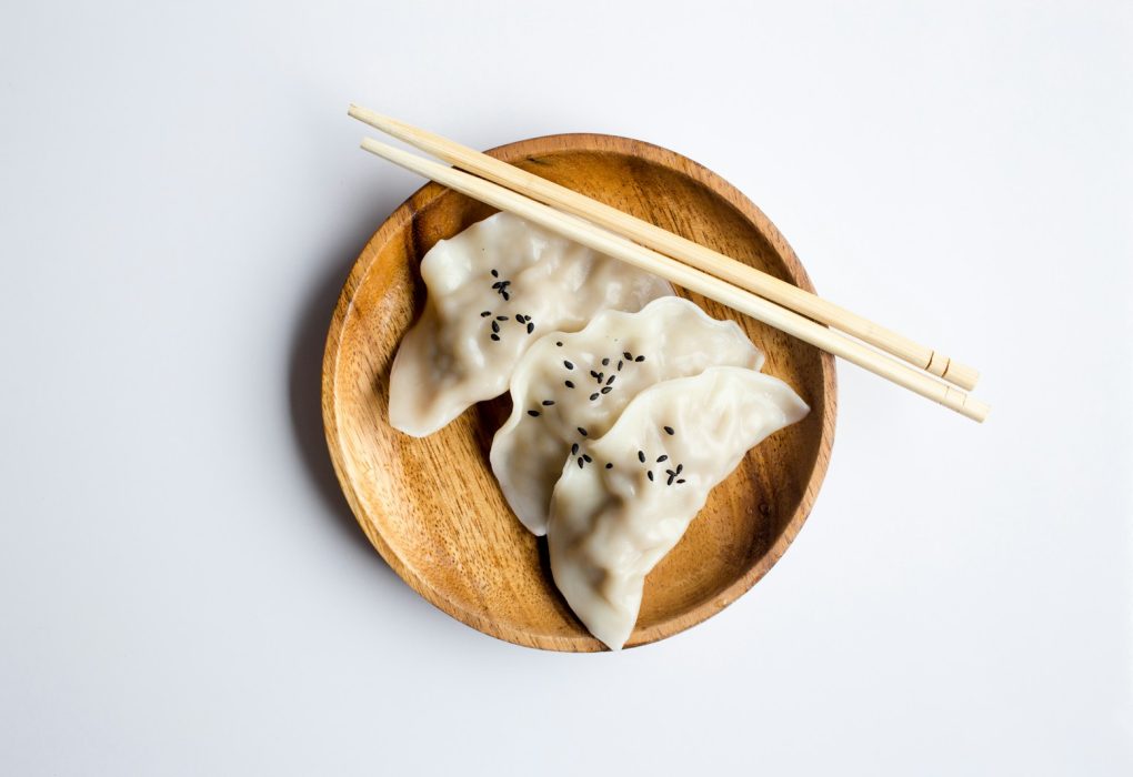 three white dimsum on brown bowl